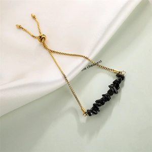 Detail of adjustable gold box chain bracelet with natural black crystal stone beads