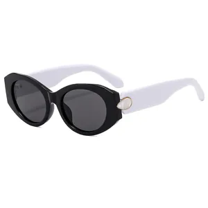Fashionable retro sunglasses with black frames and creamy white temples with gold accents
