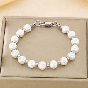 Close-up of white freshwater pearls and silver beads bracelet with metal lobster clasp