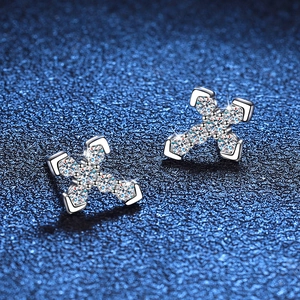 Sparkling S925 sterling silver cross earrings with full pave moissanite on blue background