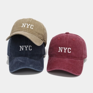Close-up of vintage washed cotton baseball caps with 3D NYC embroidery in three colors