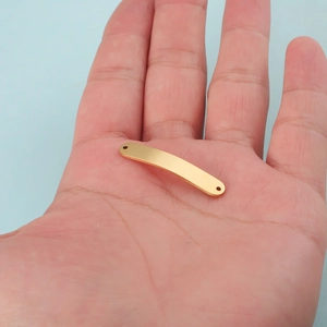 Polished gold curved stainless steel bar connector for DIY jewelry making on palm