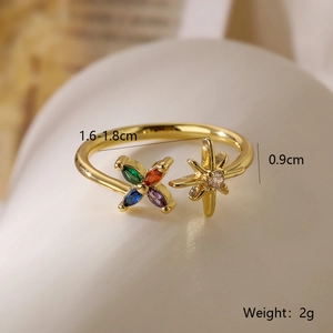 Macro shot of gold adjustable ring featuring clover and star icons with dimensions