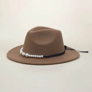 Detail of brown wool fedora hat featuring white pearls and black ribbon trimming