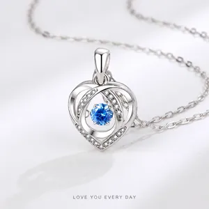 Detail of S925 sterling silver heart pendant with blue gemstone and micro-pave stones