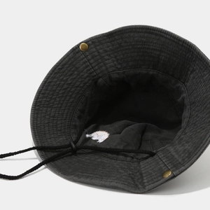 Detail view of cotton sun hat featuring animal embroidery and adjustable windproof rope