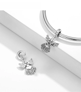 Macro shot of S925 sterling silver angel charm with detailed engraving on snake chain
