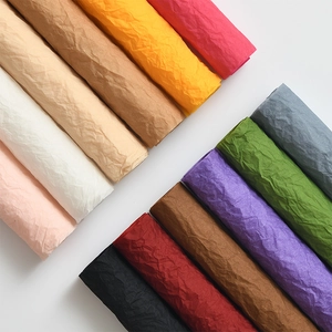 Colorful wrinkled flower wrapping paper rolls in various shades for floral packaging