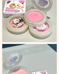 Close-up of matte peach cat-themed blush in transparent case with cute feline illustration