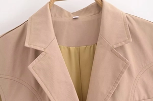 Close-up of khaki sleeveless blazer lapel and collar detail with size S label