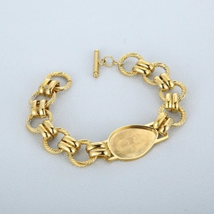 Golden OT toggle clasp chunky chain bracelet featuring a polished oval charm plate