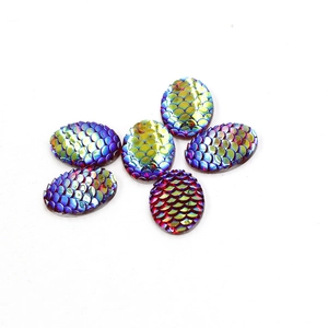 Macro shot of 13x18mm rainbow dragon scale resin teardrop cabochons with AB coating