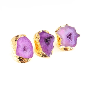 Detailed view of natural purple agate geode rings with hammered gold brass bands