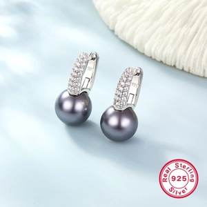 Macro shot of S925 sterling silver dark grey pearl earrings with sparkling white zircons