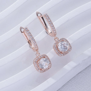 Macro view of rose gold square drop earrings with sparkling zircon pave and secure ear hooks