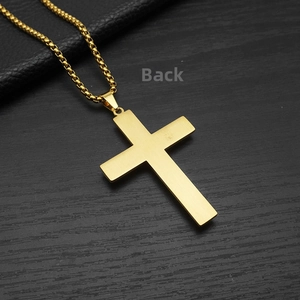 Macro view of the brushed gold cross pendant back and stainless steel box chain