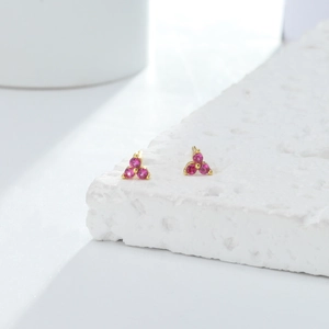 Macro detail view of minimalist S925 sterling silver stud earrings with pink zircon stones