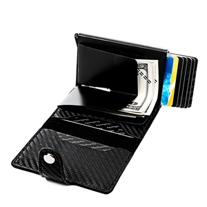 Close-up of black carbon fiber RFID wallet with metal money clip and pop-up card mechanism