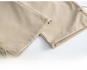 Detailed macro view of khaki cargo pants hem featuring adjustable elastic drawstring