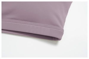Close-up of double-needle hem stitching on mauve high-stretch sports bra fabric