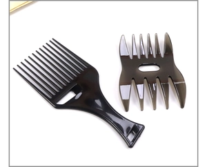 Close-up of black plastic tail comb and brown wide-tooth comb for retro men styling