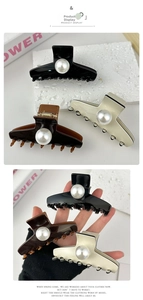 Detailed view of large pearl hair claws in black, coffee, and cream white glossy resin