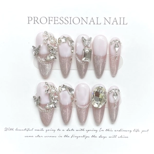 Detailed view of handmade stiletto nails with purple gradient and luxury rhinestones