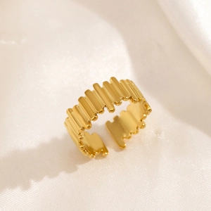 Minimalist 18K gold plated geometric ripple ring on white silk background