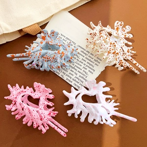 Chic oversized coral-shaped hair claws with heart cutouts in various spotted patterns