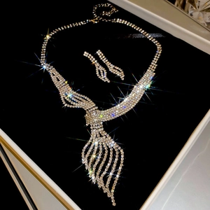 Detailed view of rhinestone necklace and earring set in a white jewelry gift box