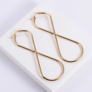 Elegant gold infinity shaped stainless steel drop earrings for women on a white base