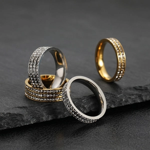 Macro detail of 2mm thin titanium steel rings with rhinestones on slate base