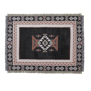 Bohemian Aztec style woven picnic blanket with geometric patterns and fringe tassels