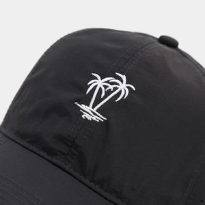 Close-up of black breathable mesh baseball cap with white palm tree embroidery detail
