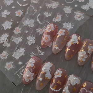 3D white floral nail stickers with pearls and gold foil for elegant French manicure