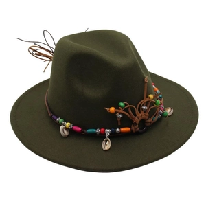 Detailed texture of dark olive green wool felt hat with colorful beads and shell accents
