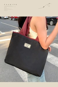 Macro detail of waterproof tote bag with high-capacity design and burgundy handles
