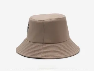 Detail view of khaki bucket hat featuring black embroidery and reinforced stitching