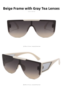 Detail view of cream shield sunglasses with gradient tea lenses and cutout temples
