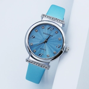 Detail of blue sunray dial quartz watch with sparkling rhinestones and leather strap
