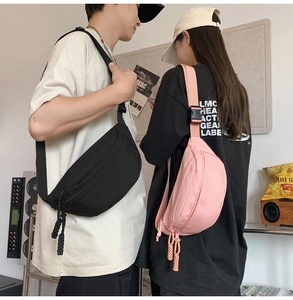 Close-up of black and pink waterproof nylon crossbody bags with woven zipper pulls