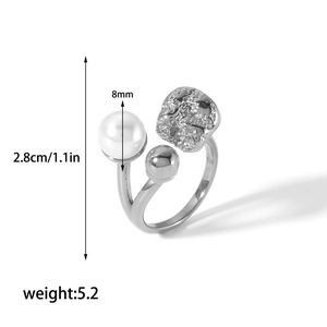 Detailed view of silver open ring with 8mm pearl and textured lava metal design