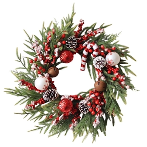 Christmas wreath with pine needles, red berries, cones, candy canes, and bells on white back