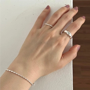 Detail shot of 925 sterling silver twisted ring and braided ring on hand