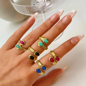 Detail showing 18k gold plated stainless steel wave rings with colorful inset natural stones