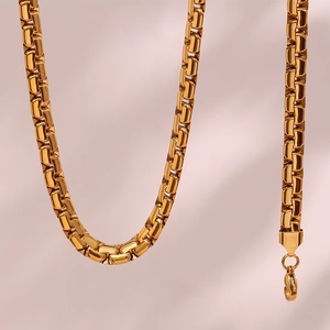 Macro shot of 6.2mm gold flat box chain necklace with a secure lobster clasp closure