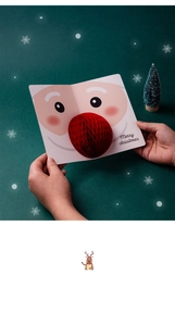Detail of 3D Christmas card featuring a red honeycomb paper nose on a Santa Claus design