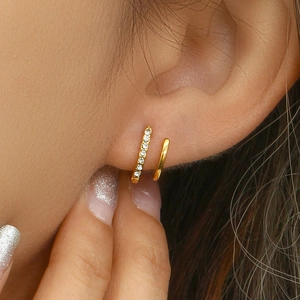 Detail view of double-layer gold plated earrings featuring white cubic zirconia accents
