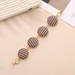 Close-up of heart-shaped zinc alloy bracelet with houndstooth patterned round charms