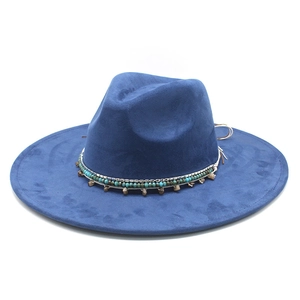 Detail of navy blue suede fedora featuring turquoise beads and western style metal chain